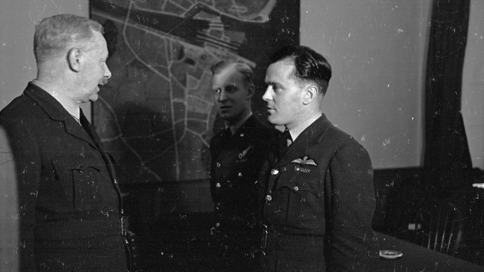 British Air Force officer and commander-in-chief Sir Arthur 'Bomber' Harris (left), of Bomber Command RAF, with Wing Commander Reynolds and Flight Lieutenant Sismore in the bunker at Bomber Command, 10th July 1943. Original Publication : Picture Post - 1473 - The Man Who Picks The Target For Tonight - pub. 1943 (Photo by Leonard McCombe/Picture Post/Getty Images)