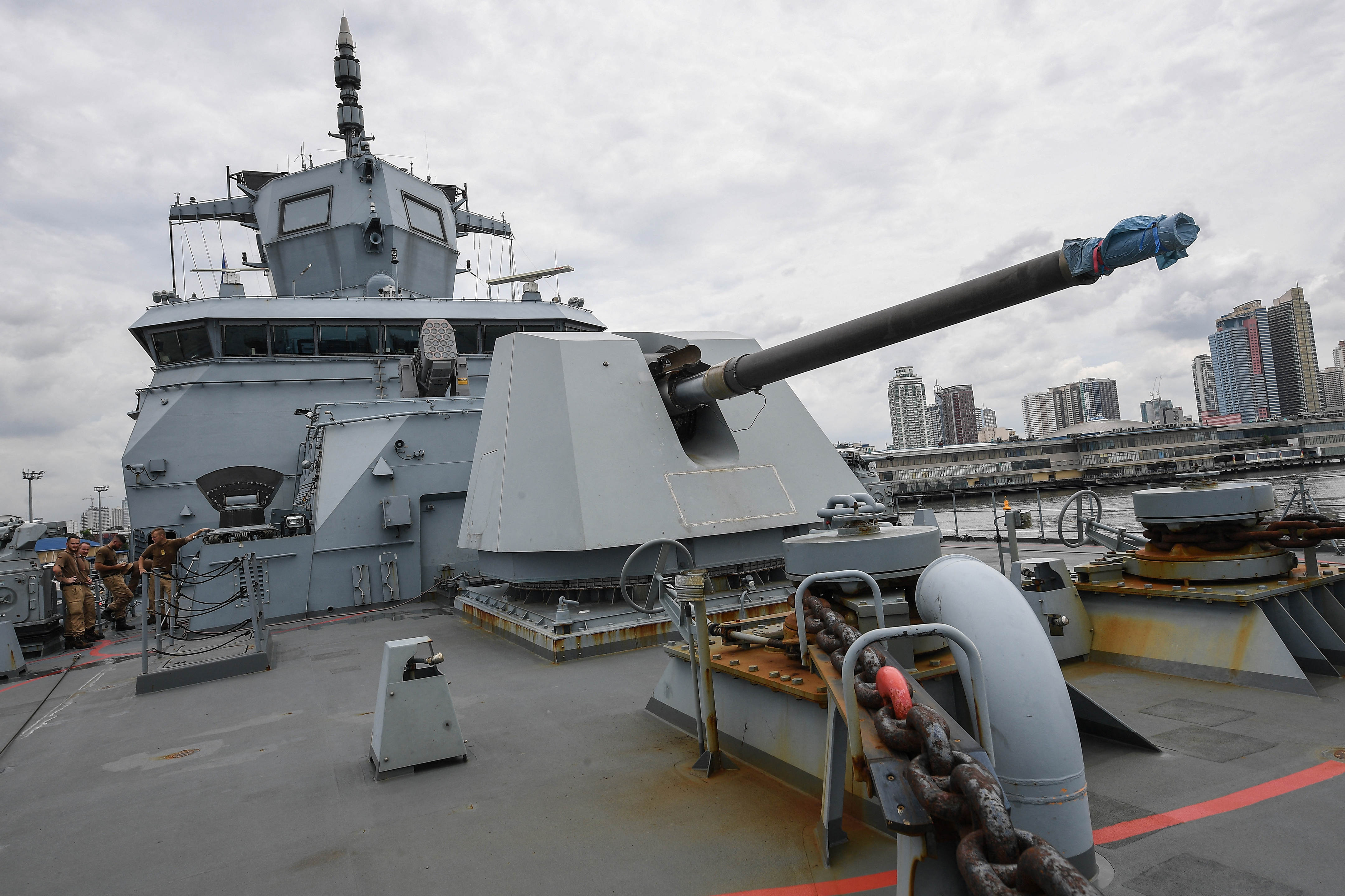 Crew of the German Navy frigate FS Baden-Wurttemberg stand next to a 127mm gun after docking during a port call in Manila on September 16, 2024. (Photo by Ted ALJIBE / AFP) (Photo by TED ALJIBE/AFP via Getty Images)