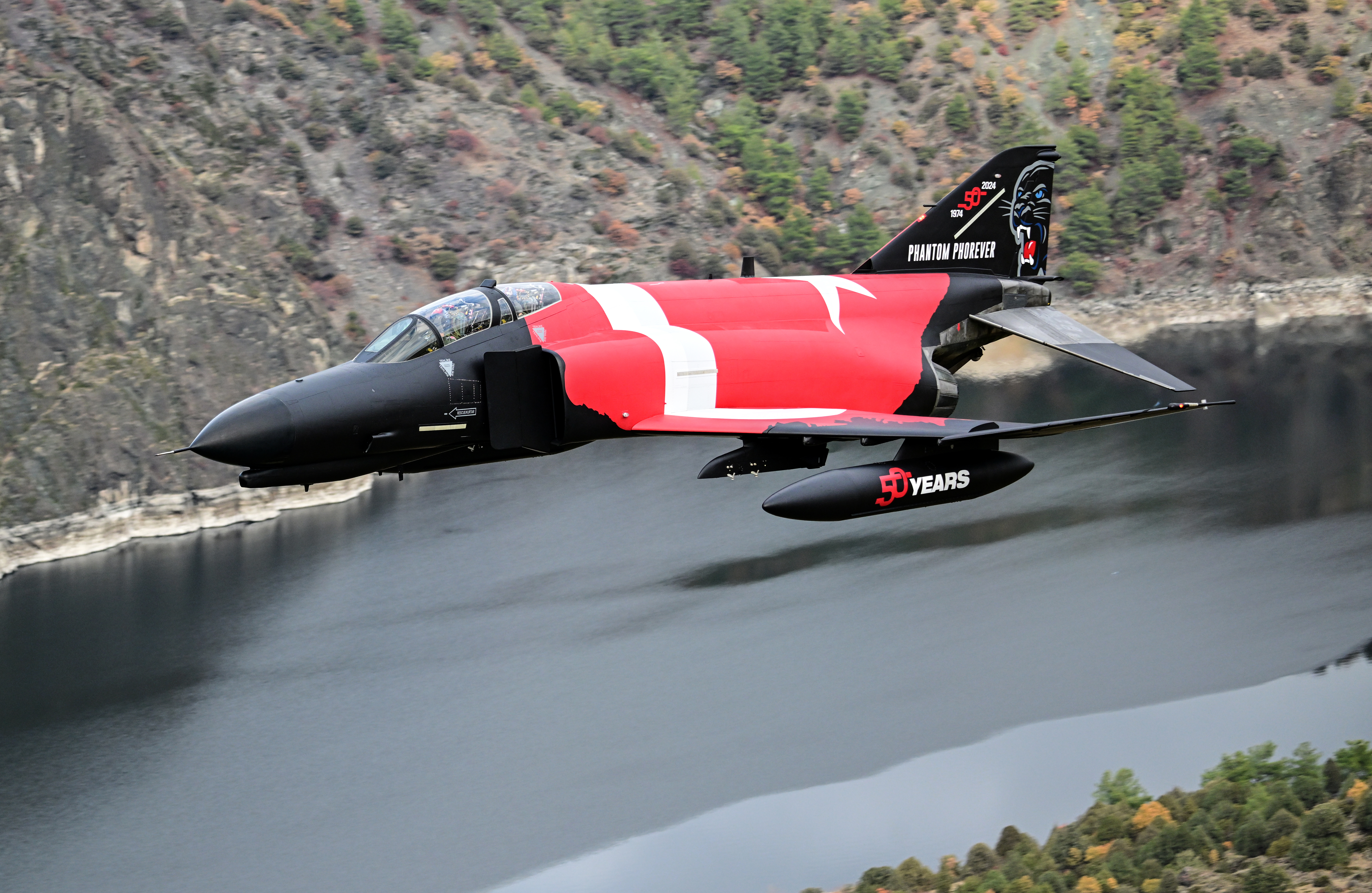 ESKISEHIR, TURKIYE - NOVEMBER 16: A Turkish Air Force F-4E Phantom II, adorned with a striking Turkish flag livery, soars in a low-altitude maneuver over Eskisehir to commemorate 50 years of service in the Turkish Air Force in Eskisehir, Turkiye on November 16, 2024. (Photo by Ali Atmaca/Anadolu via Getty Images)