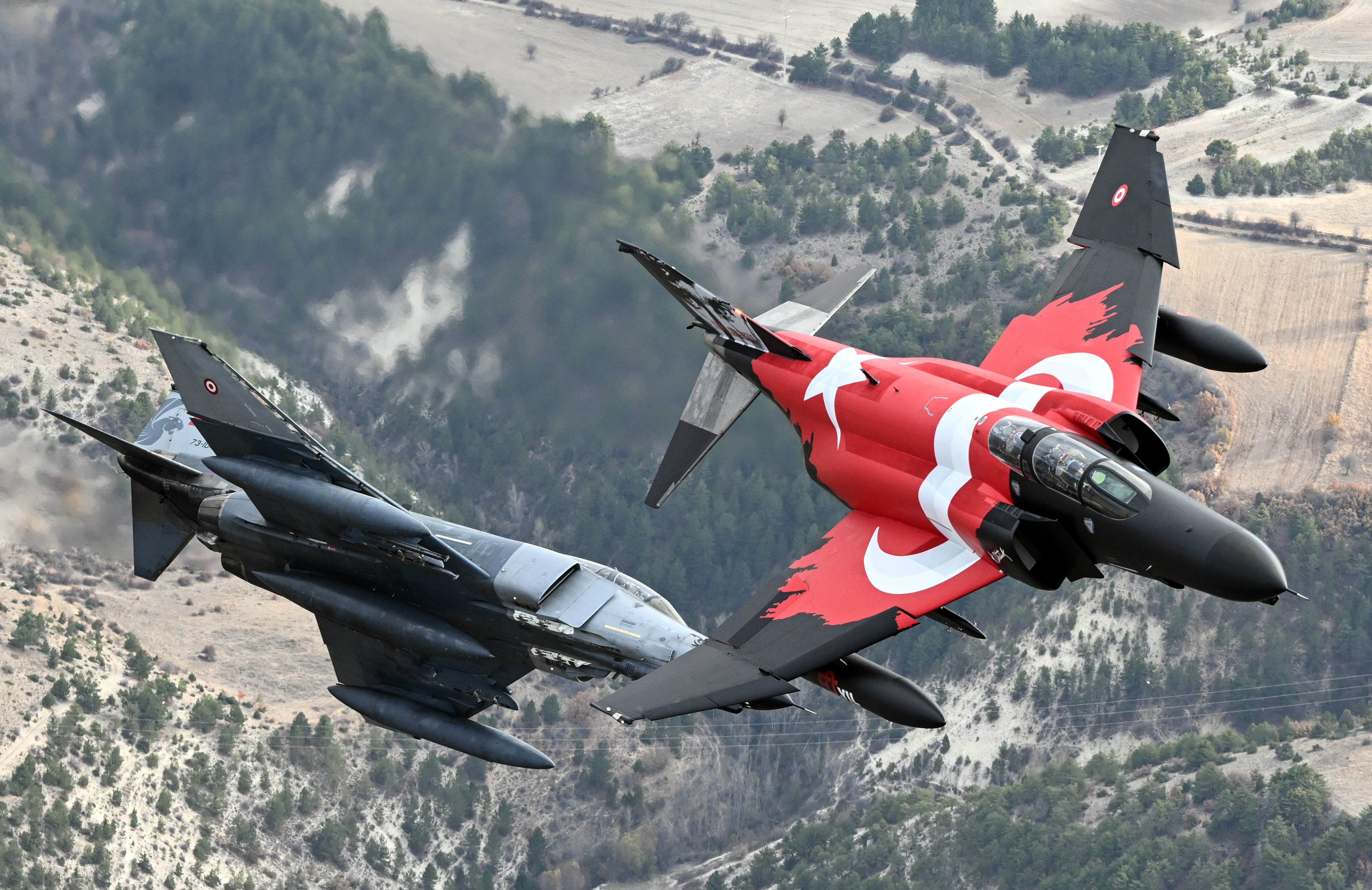 ESKISEHIR, TURKIYE - NOVEMBER 15: Turkish Air Force F-4E Phantom II, decorated with a Turkish flag, take part in training flight to commemorate 50 years of service in the Turkish Air Force in Eskisehir, Turkiye on November 15, 2024. (Photo by Ali Atmaca/Anadolu via Getty Images)