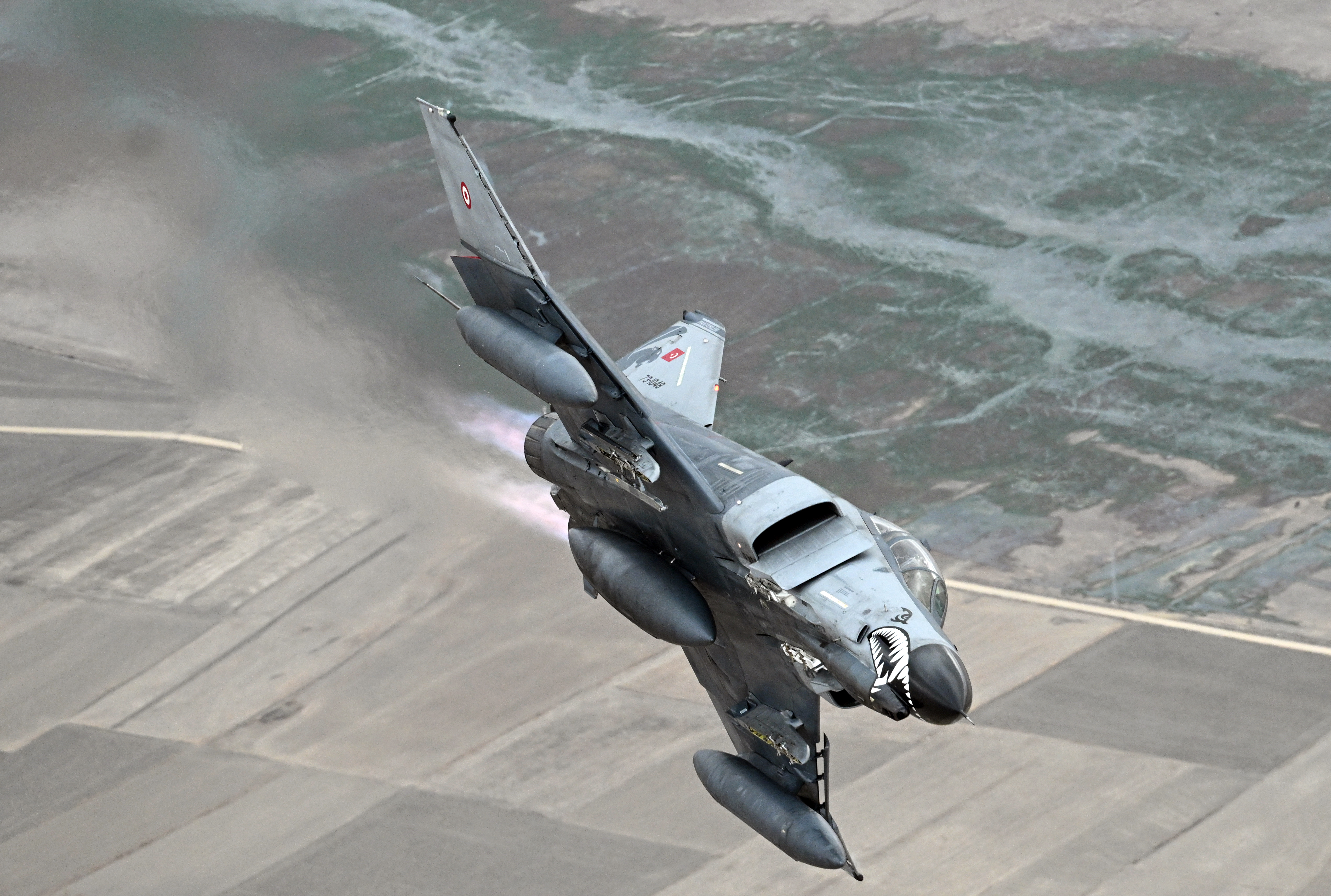 ESKISEHIR, TURKIYE - NOVEMBER 15: Turkish Air Force F-4E Phantom II, decorated with a Turkish flag, take part in training flight to commemorate 50 years of service in the Turkish Air Force in Eskisehir, Turkiye on November 15, 2024. (Photo by Ali Atmaca/Anadolu via Getty Images)