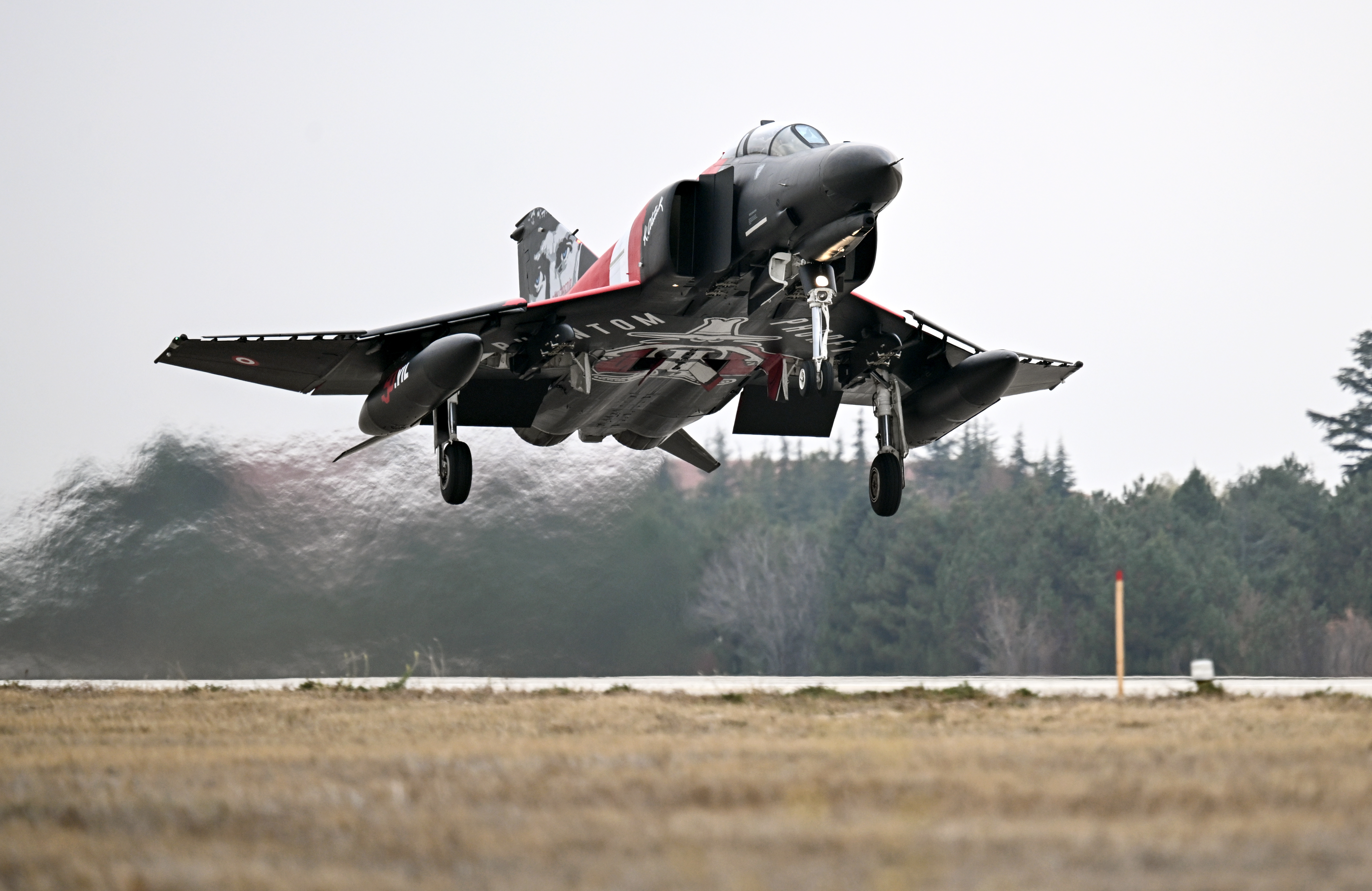 ESKISEHIR, TURKIYE - NOVEMBER 17: Turkish Air Force F-4E Phantom II, decorated with a Turkish flag, take part in training flight to commemorate 50 years of service in the Turkish Air Force in Eskisehir, Turkiye on November 17, 2024. (Photo by Ali Atmaca/Anadolu via Getty Images)