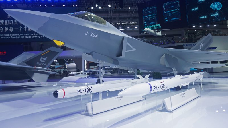 Visitors view a model of the aviation industry J-35A stealth fighter jet at the 15th China International Aviation and Aerospace Expo in Zhuhai, Guangdong province, China, on November 10, 2024.