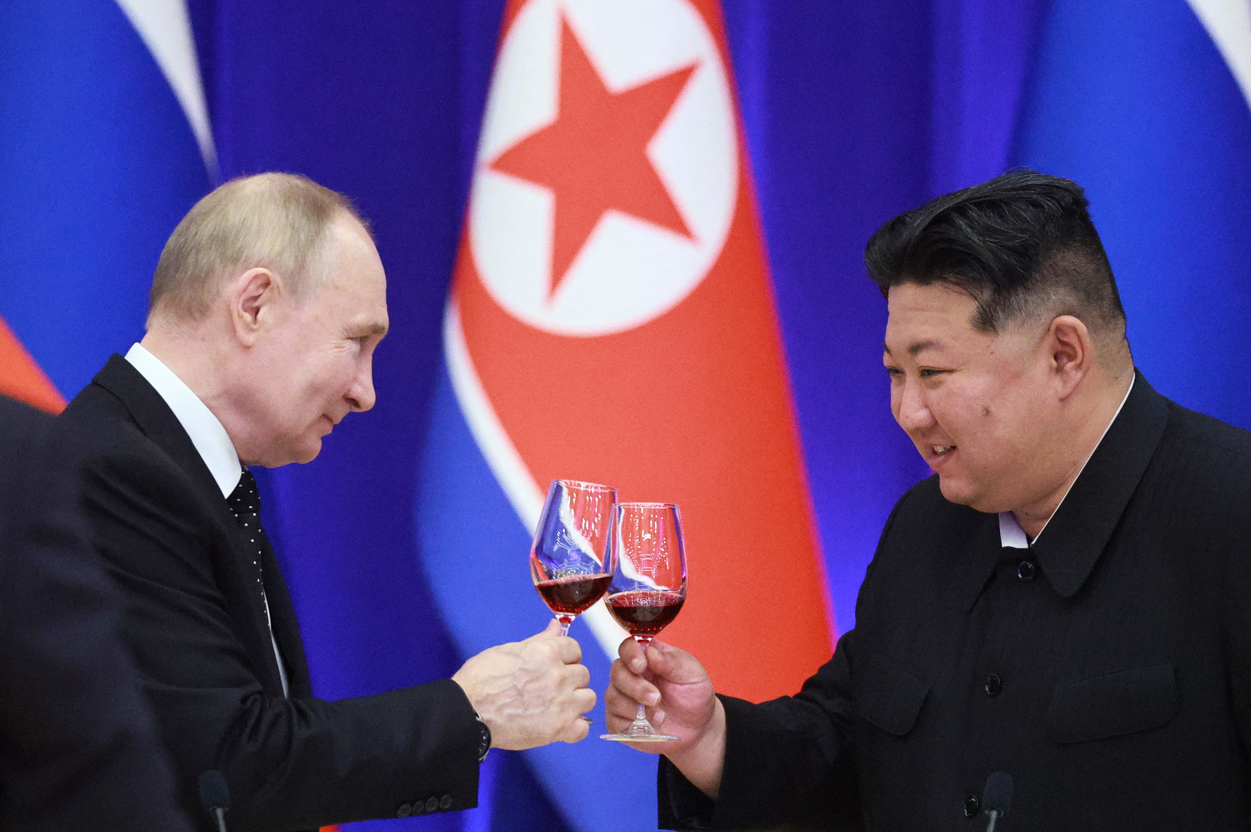 TOPSHOT - In this pool photograph distributed by the Russian state agency Sputnik, Russian President Vladimir Putin and North Korean leader Kim Jong Un toast during a reception at the Mongnangwan Reception House in Pyongyang on June 19, 2024. Putin enjoyed a red carpet welcome, a military ceremony and an embrace from North Korea's Kim Jong Un during a state visit to Pyongyang where they both pledged to forge closer ties. (Photo by Vladimir Smirnov / POOL / AFP) / -- Editor's note : this image is distributed by the Russian state owned agency Sputnik -- (Photo by VLADIMIR SMIRNOV/POOL/AFP via Getty Images)