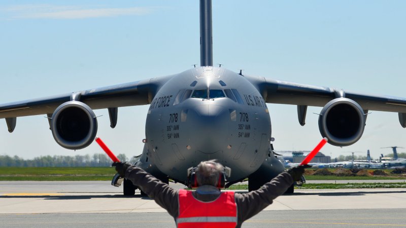 Bill Kennedy, 436th Aircraft Maintenance Squadron transit alert, marshals a U.S. Air Force C-17 Globemaster III at Dover Air Force Base, Del., April 26, 2015. The aircraft is loaded with 69 members of the Fairfax County Urban Search and Rescue Team, their supplies and equipment, and six K-9s, to assist Nepal with rescue operations after the country was struck by a 7.8-magnitude earthquake.