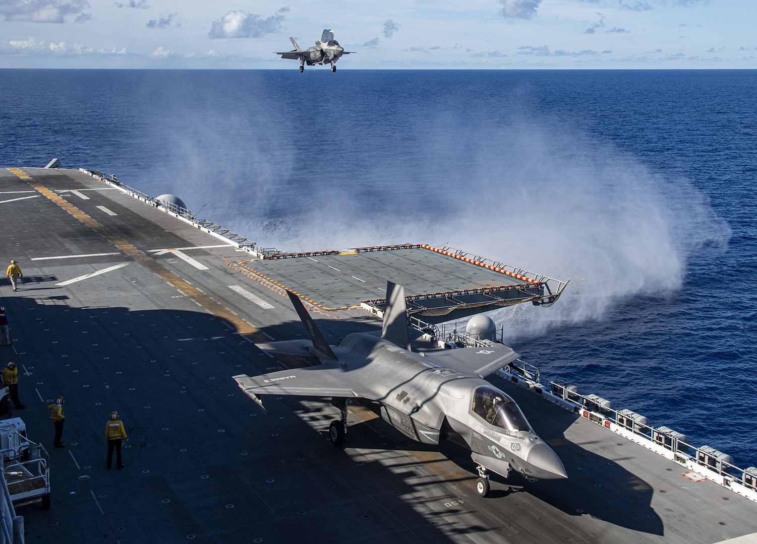 240713-N-QR506-1108 PHILIPPINE SEA (July 13, 2024) An F-35B Lightning II fighter aircraft from Marine Fighter Attack Squadron (VMFA) 121 prepares to land on the flight deck of the forward-deployed amphibious assault ship USS America (LHA 6) while conducting routine operations in the Philippine Sea, July 13. America, lead ship of the America Amphibious Ready Group, is operating in the U.S. 7th Fleet area of operations. U.S. 7th Fleet is the U.S. Navy’s largest forward-deployed numbered fleet, and routinely interacts and operates with allies and partners in preserving a free and open Indo-Pacific region. (U.S. Navy photo by Mass Communication Specialist Seaman Jeadan Andre)