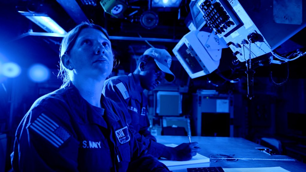 Sailors assigned to the Navy destroyer USS Carney (DDG-64) at work inside the ship's combat information center on July 17, 2024.