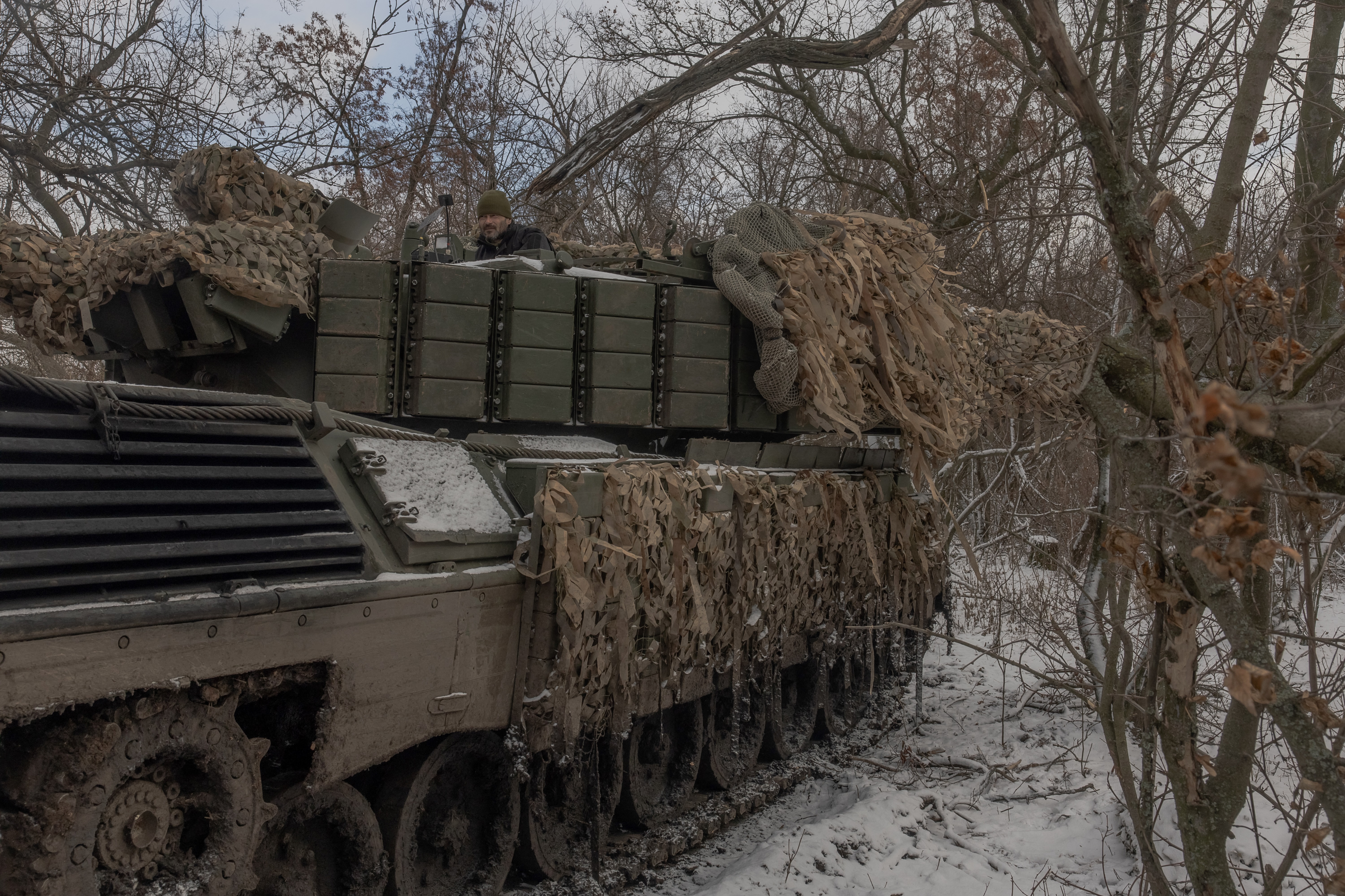 A Ukrainian tank crew member of the 68th Jaeger Brigade stands on a Leopard 1A5 tank at the position where they take a break in fighting, near Pokrovsk, the eastern Donetsk region, on December 13, 2024, amid the Russian invasion of Ukraine. (Photo by Roman PILIPEY / AFP) (Photo by ROMAN PILIPEY/AFP via Getty Images)