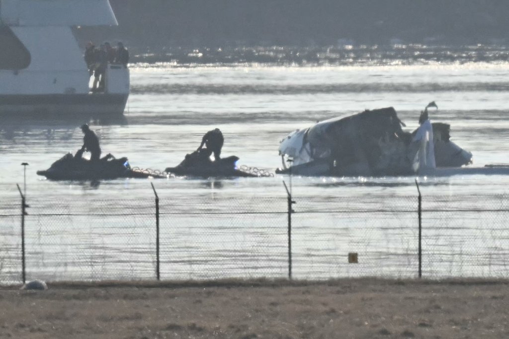 Part of the wreckage is seen as rescue crews search the waters of the Potomac River American Airlines flight 5342 on approach to Reagan National Airport crashed into the river after colliding with a US Army helicopter, near Washington, DC, on January 30, 2025. There are likely no survivors from a collision between a passenger jet and US Army helicopter in Washington, officials said Thursday, as recovery operations pulled 28 bodies from the river into which both crashed. (Photo by ANDREW CABALLERO-REYNOLDS / AFP) (Photo by ANDREW CABALLERO-REYNOLDS/AFP via Getty Images)