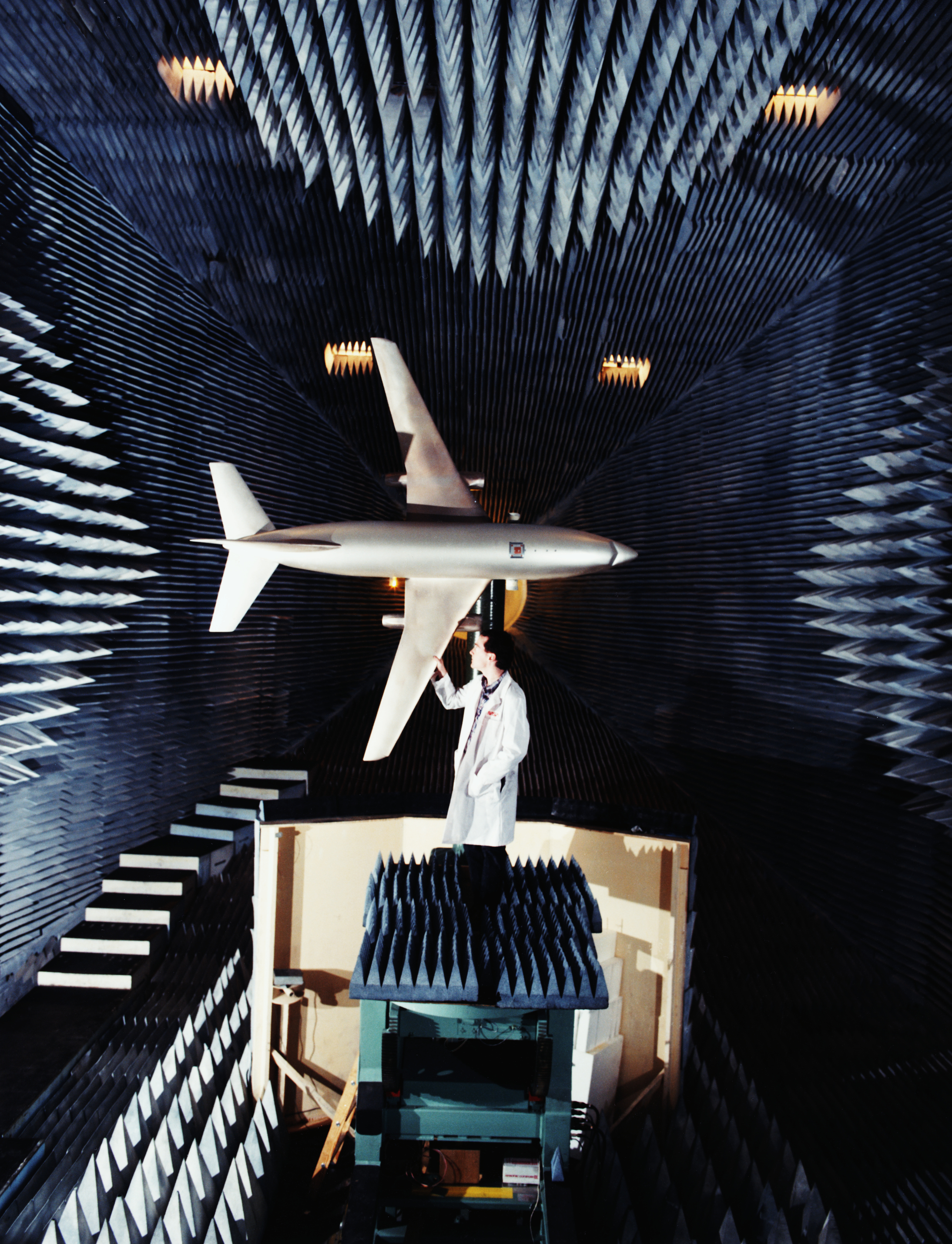 A one-eleventh scale model of a Boeing 737 aircraft is shown during antenna performance measurement in NASA Langley Research Center's Low Frequency Antenna Test Facility. The state-of-the-art test facility is used to provide a simulated free space environment for evaluating antennas over the 0.100 to 40 GHz frequency range. The radio frequency performance of the scale model top fuselage mounted antenna was measured at 11.55 GHz. This research was done in support of the development of the Traffic Alert and Collision Avoidance System (TCAS) for commercial aircraft. (Photo by © CORBIS/Corbis via Getty Images)