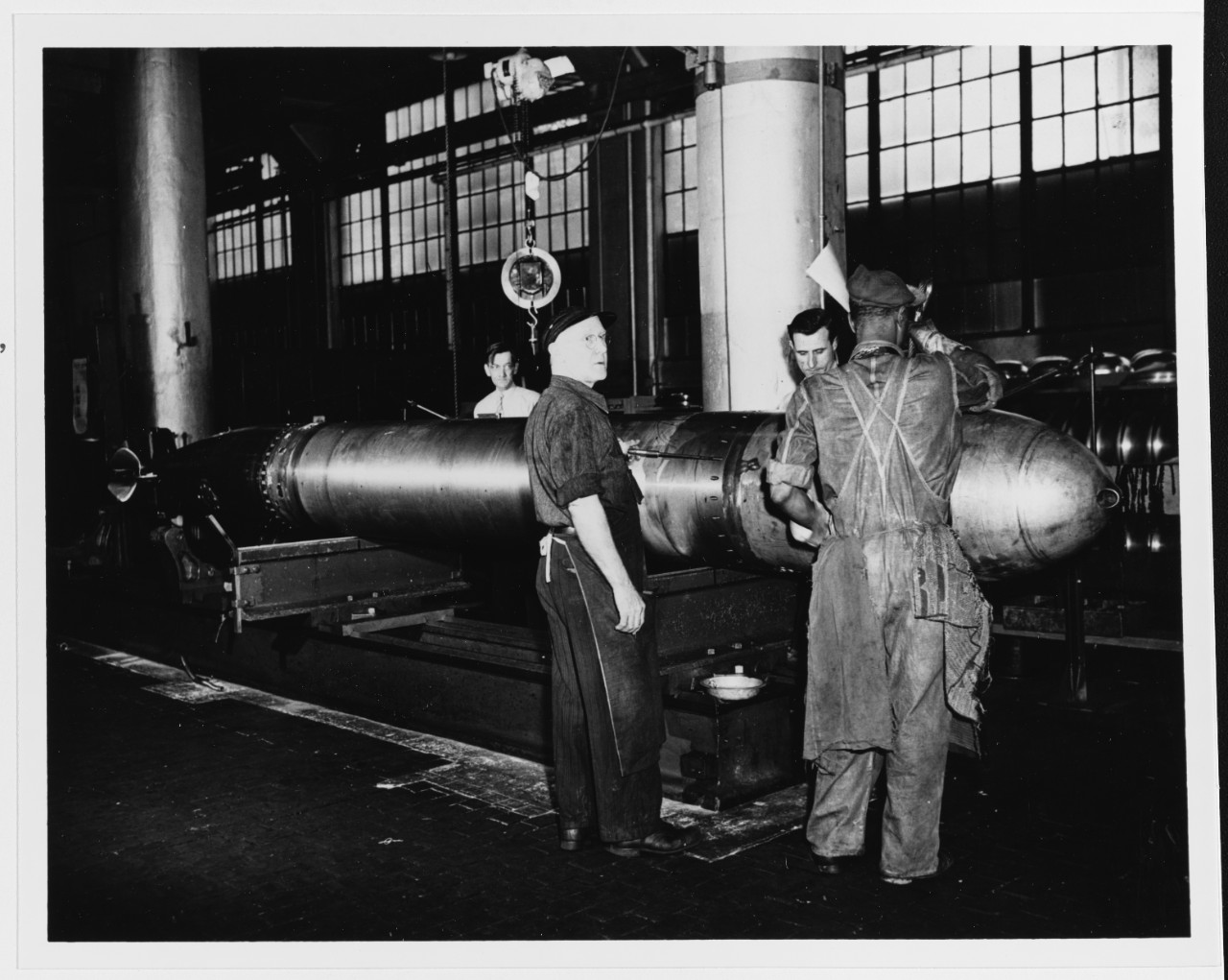 A MK14 Torpedo is balanced in shop 41, during World War II. (U.S. Navy)