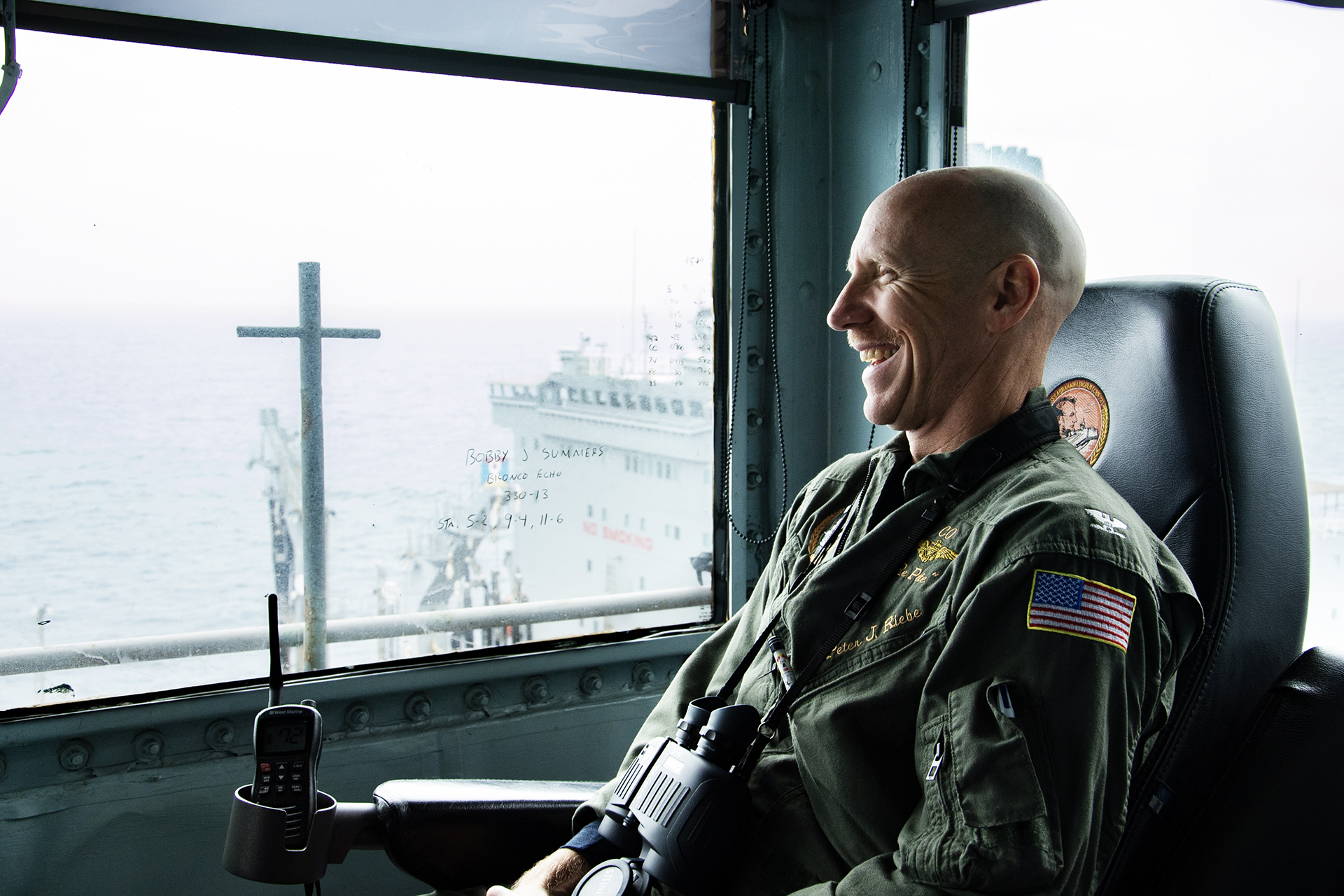 240530-N-IJ966-1094 PACIFIC OCEAN (May 30, 2024) Capt. Pete Riebe, commanding officer of the Nimitz-class aircraft carrier USS Abraham Lincoln (CVN 72) oversees a replenishment-at-sea (RAS) with Henry J. Kaiser-class fleet replenishment oiler USNS Pecos (T-AO 197). Abraham Lincoln, flagship of Carrier Strike Group Three, is underway conducting integrated exercises to bolster strike group readiness and capability in the U.S. 3rd Fleet area of operations. (U.S. Navy photo by Mass Communication Specialist Seaman Nathaly Cruz)