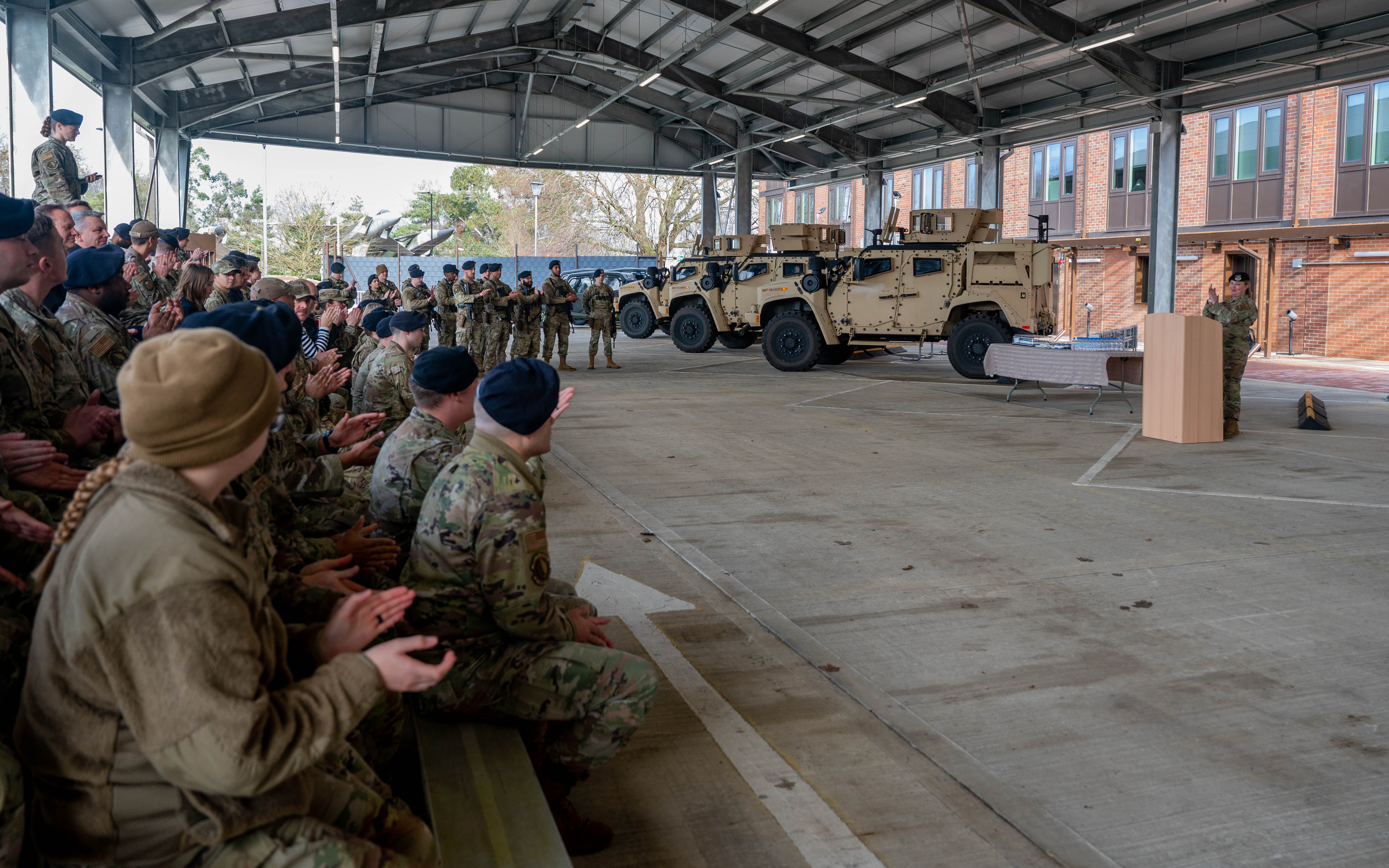 U.S. Air Force Master Sgt. Danielle Heiser, 48th Security Forces Squadron operations section chief, gives remarks at a ribbon cutting ceremony for new security forces facilities at RAF Lakenheath, England, Feb. 15, 2024. The new facilities will help enhance the 48th SFS’ contingency response capabilities. (U.S. Air Force photo by Senior Airman Olivia Gibson)