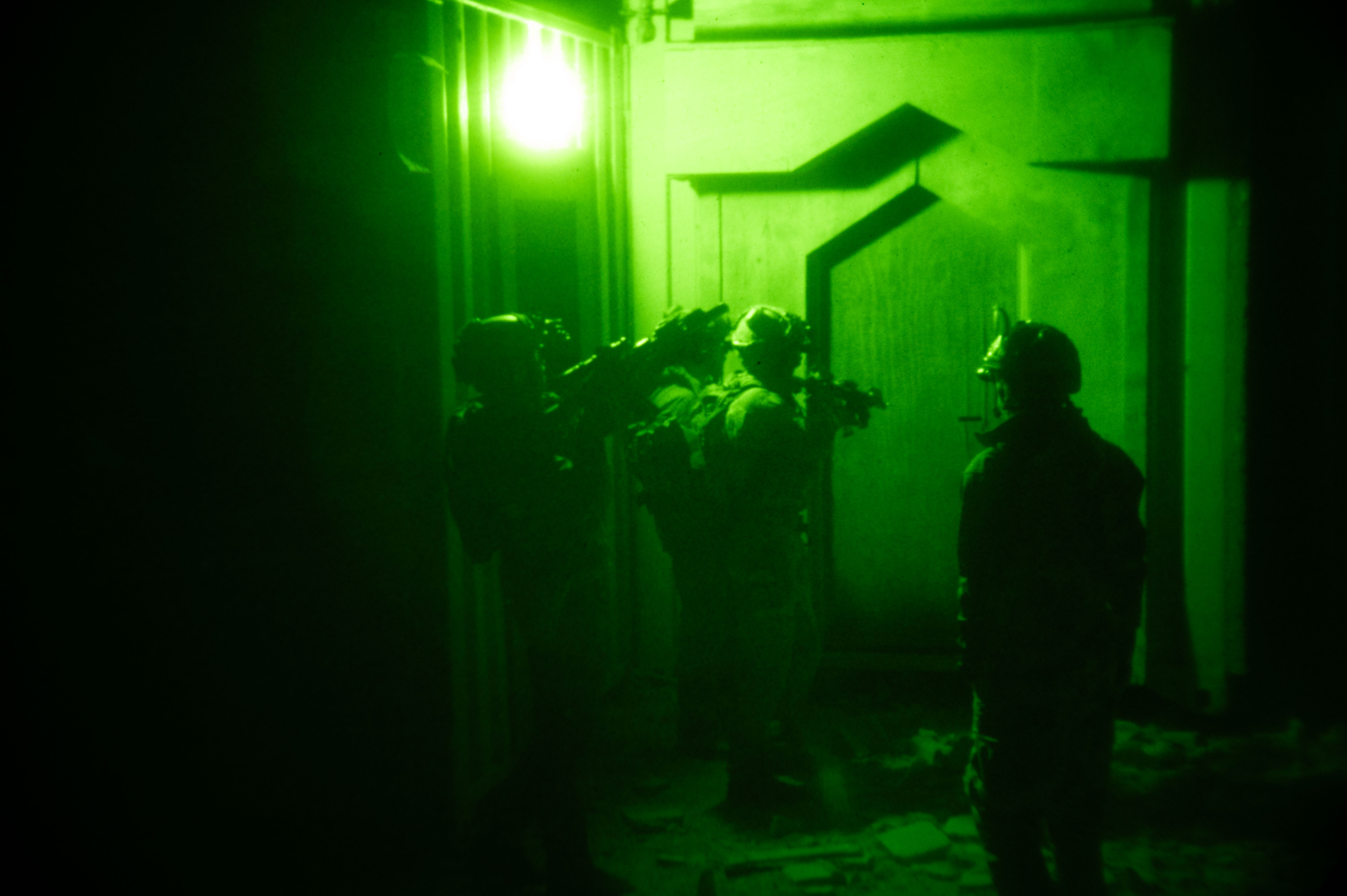 West Coast-based Naval Special Warfare (NSW) operators prepare to enter a building while conducting nighttime direct action raid training at Fort Irwin. Naval Special Warfare is the nation's elite maritime special operations force, uniquely positioned to extend the Fleet's reach and gain and maintain access for the Joint Force in competition and conflict.