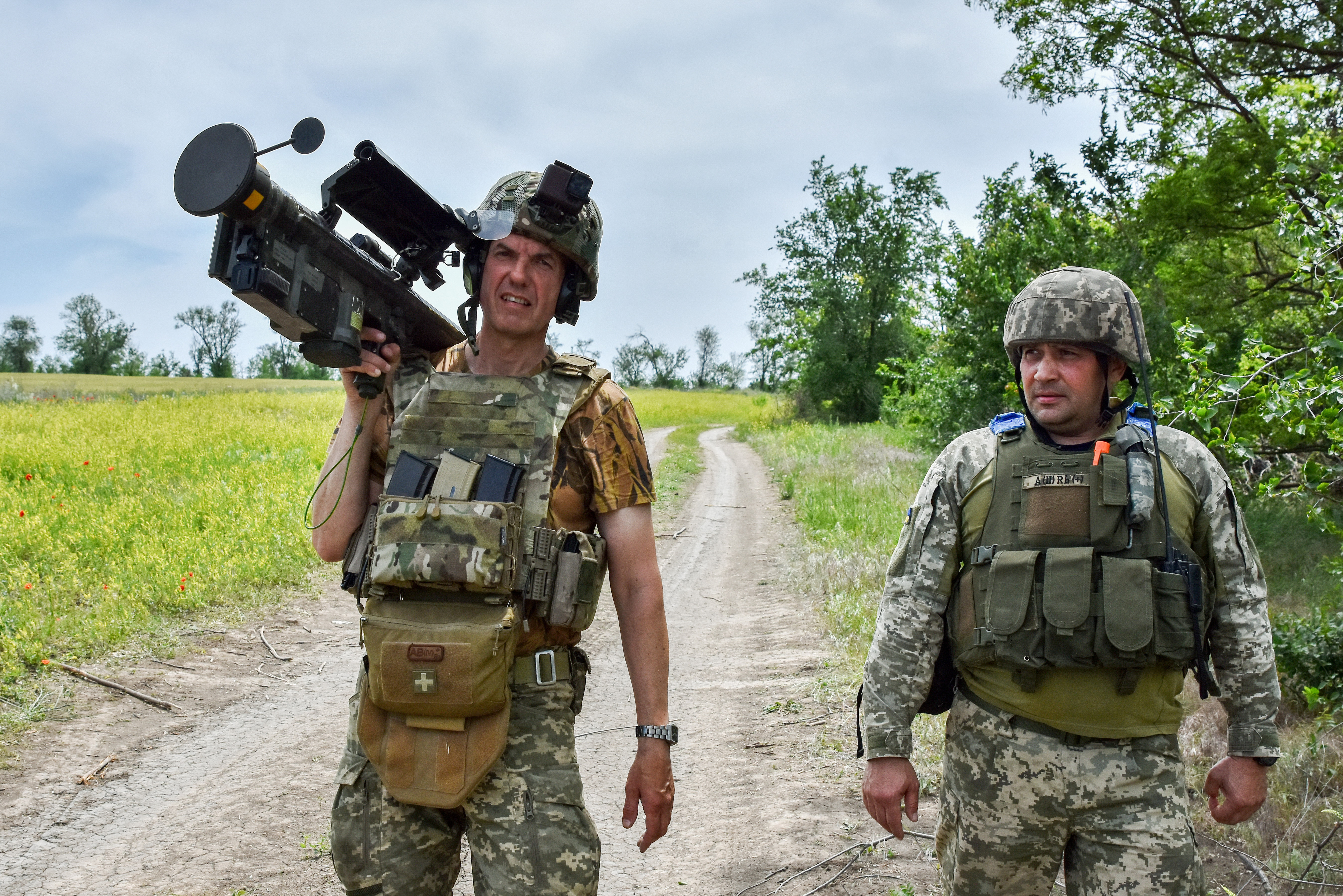 ORIKHIV, ZAPORIZHZHIA, UKRAINE - 2024/05/28: Ukrainian servicemen (air defence unit) walk down the road with a US Stinger air defence missile launcher on the front line in Zaporizhzhia region. The U.S. Department of Defense has announced a new military aid package for Ukraine. This Presidential Drawdown Authority package has an estimated value of $225 million. The latest defense package will provide Ukraine with additional capabilities to meet its most urgent battlefield needs, such as air defense interceptors; artillery systems and munitions; armored vehicles; and anti-tank weapons. (Photo by Andriy Andriyenko/SOPA Images/LightRocket via Getty Images)