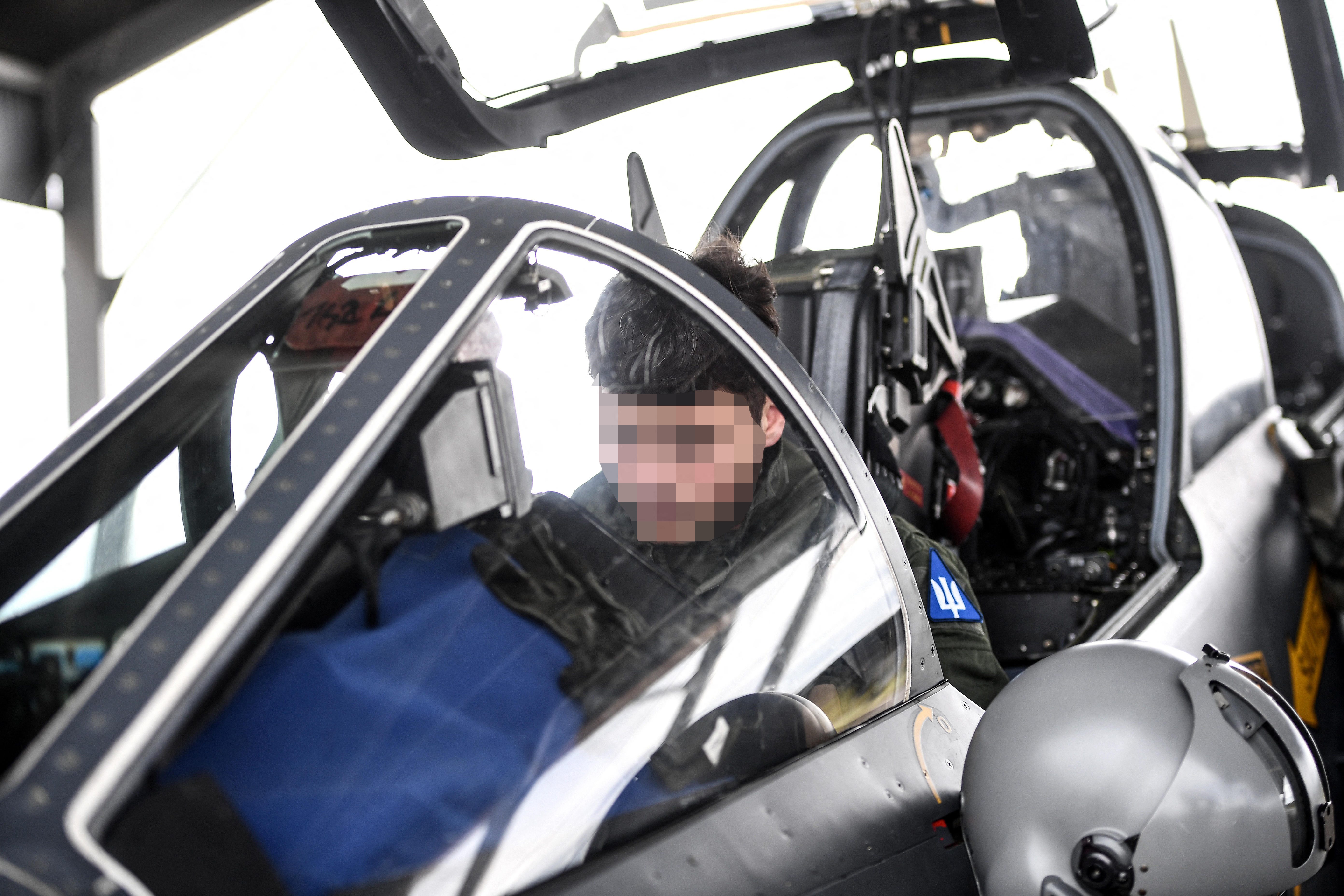 An Ukrainian trainee gets ready ahead of a flight with an unseen French military instructor onboard an Alpha Jet fighter jet, at a French Army air base in south-western France on June 14, 2024. In the face of the slow but steady advance of the Russian army in Ukraine, Ukraine urgently needs 120 to 130 fighter jets to end Moscow's dominance in the air, but to operate these technological jewels, operational pilots are needed, which takes months or even years to train. To achieve this, France has committed to training 26 Ukrainian pilots over two years, which represents an effort for its Air Force, which is used to instructing about 30 French pilots per year, as well as proposing the transfer of several Mirage 2000-5s. (Photo by Christophe ARCHAMBAULT / AFP) (Photo by CHRISTOPHE ARCHAMBAULT/AFP via Getty Images)