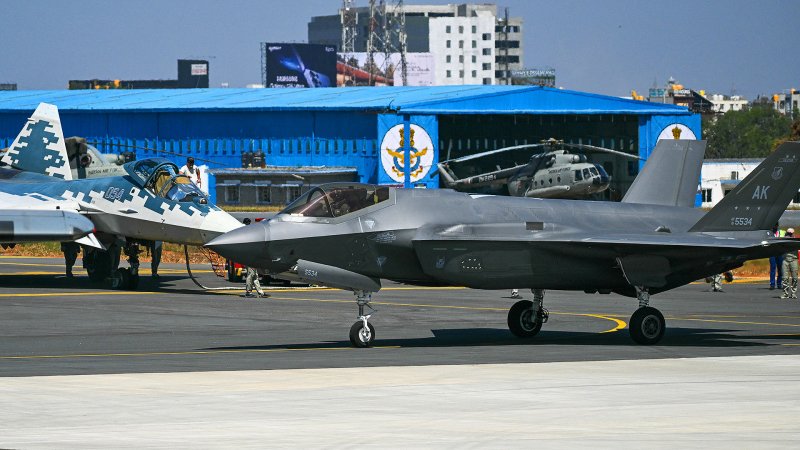 A Russian Sukhoi Su-57 (L) and U.S. Air Force's F-35 fifth-generation fighter aircrafts are pictured at the tarmac during Aero India 2025, a military aviation exhibition at the Yelahanka Air Force Station in Bengaluru on February 11, 2025. Air traffic is booming in India, even though only a tiny fraction of its people fly each year, and manufacturers are seeking lucrative deals at the flagship Aero India exhibition from February 10. (Photo by Arun SANKAR / AFP) (Photo by ARUN SANKAR/AFP via Getty Images)