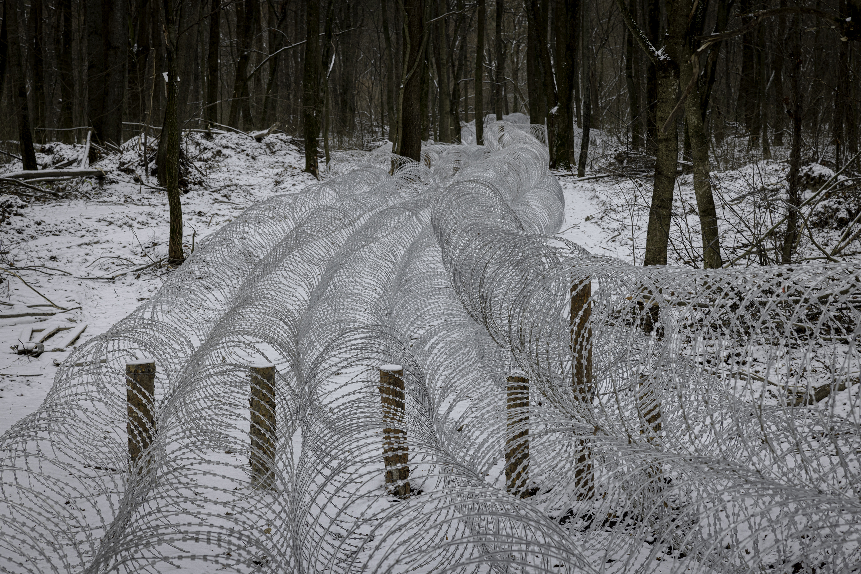  Ukrainian troops have installed defenses such as this barbed wire across many key routes within Sumy region, to protect against a potential Russian counterassault. Past Ukrainian failures to properly reinforce defenses have caused troop and territorial losses. (Photo by Serhiy Morgunov/For The Washington Post via Getty Images)